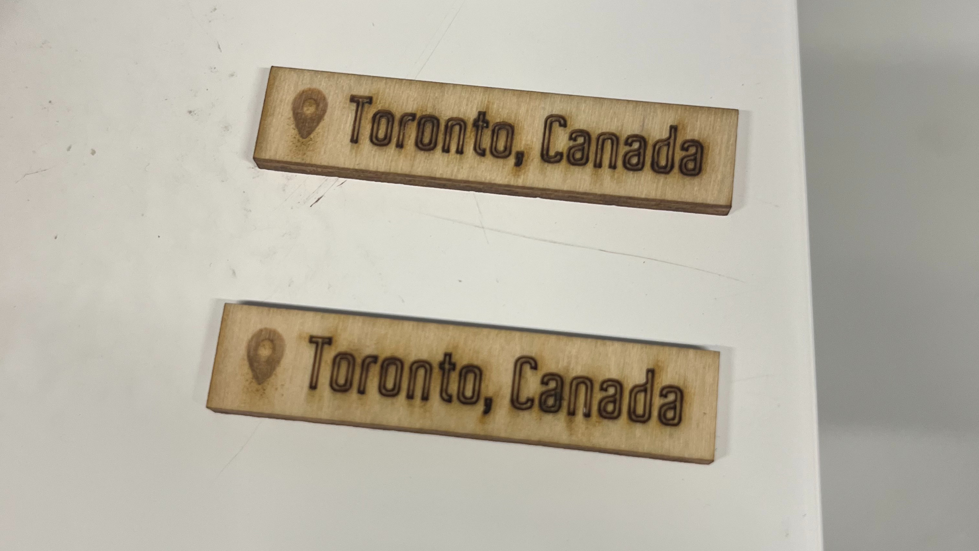 In this test, the top label was engraved at a power level of 11 and the bottom at 14. I thought they looked similar, but the Fab Lab technician explained that 11 was less burnt and would be easier to sand later.