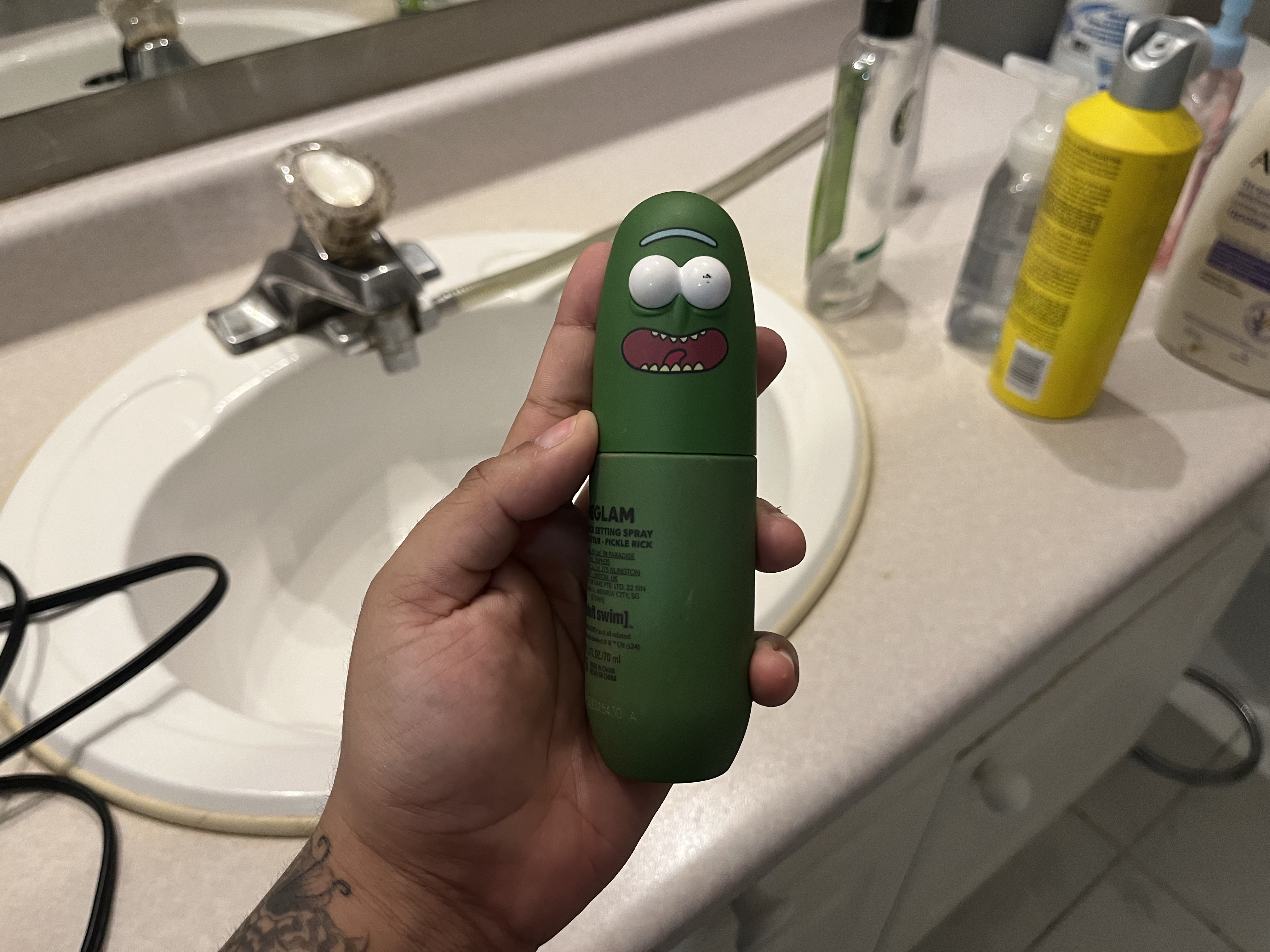 This is the sound of the setting spray being shaken, producing a soft liquid sloshing inside the bottle with a light, rhythmic swishing as it moves up and down.