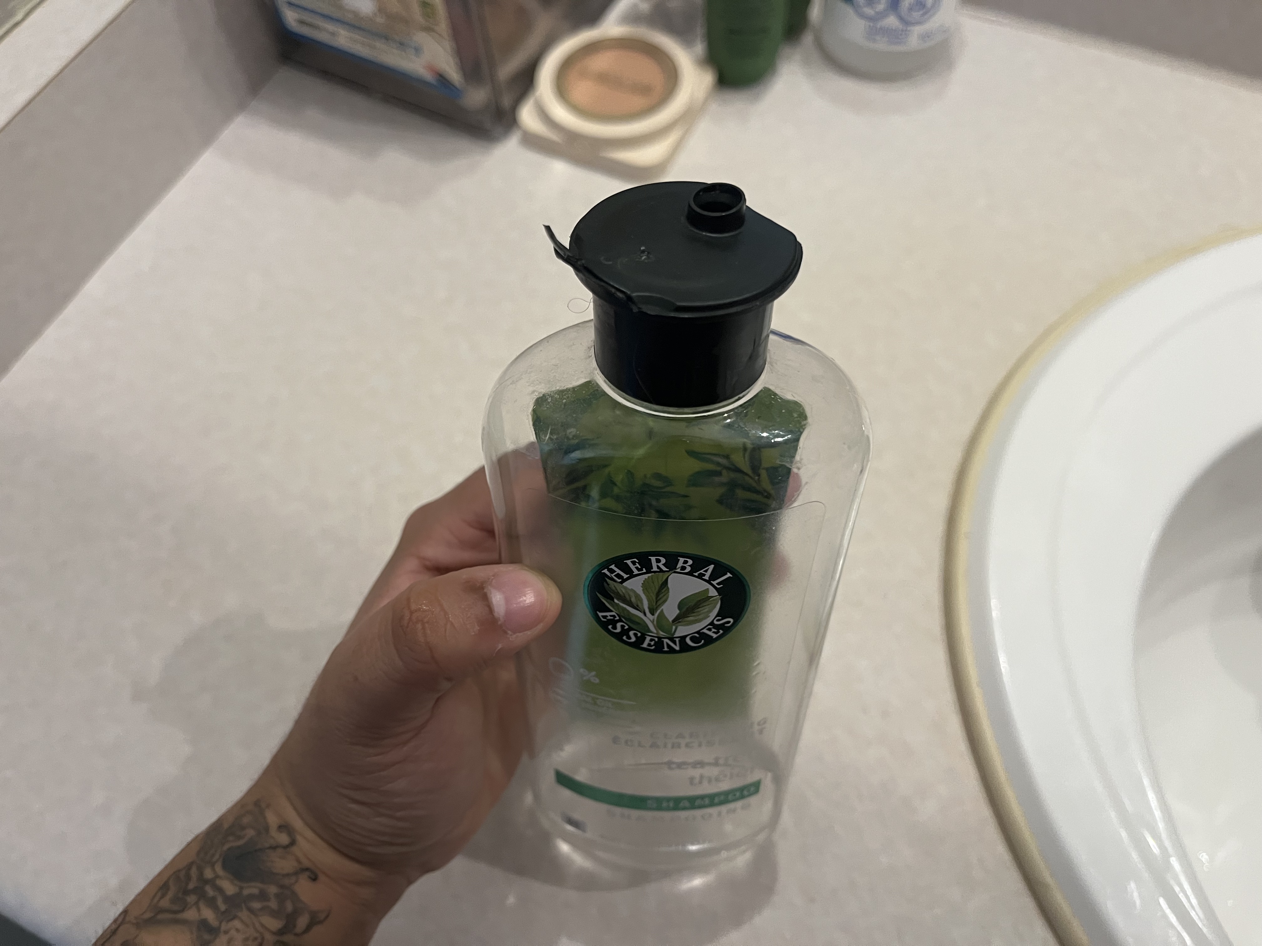 This is the sound of an empty shampoo bottle being squeezed, producing a hollow, airy whistling as air escapes through the opening