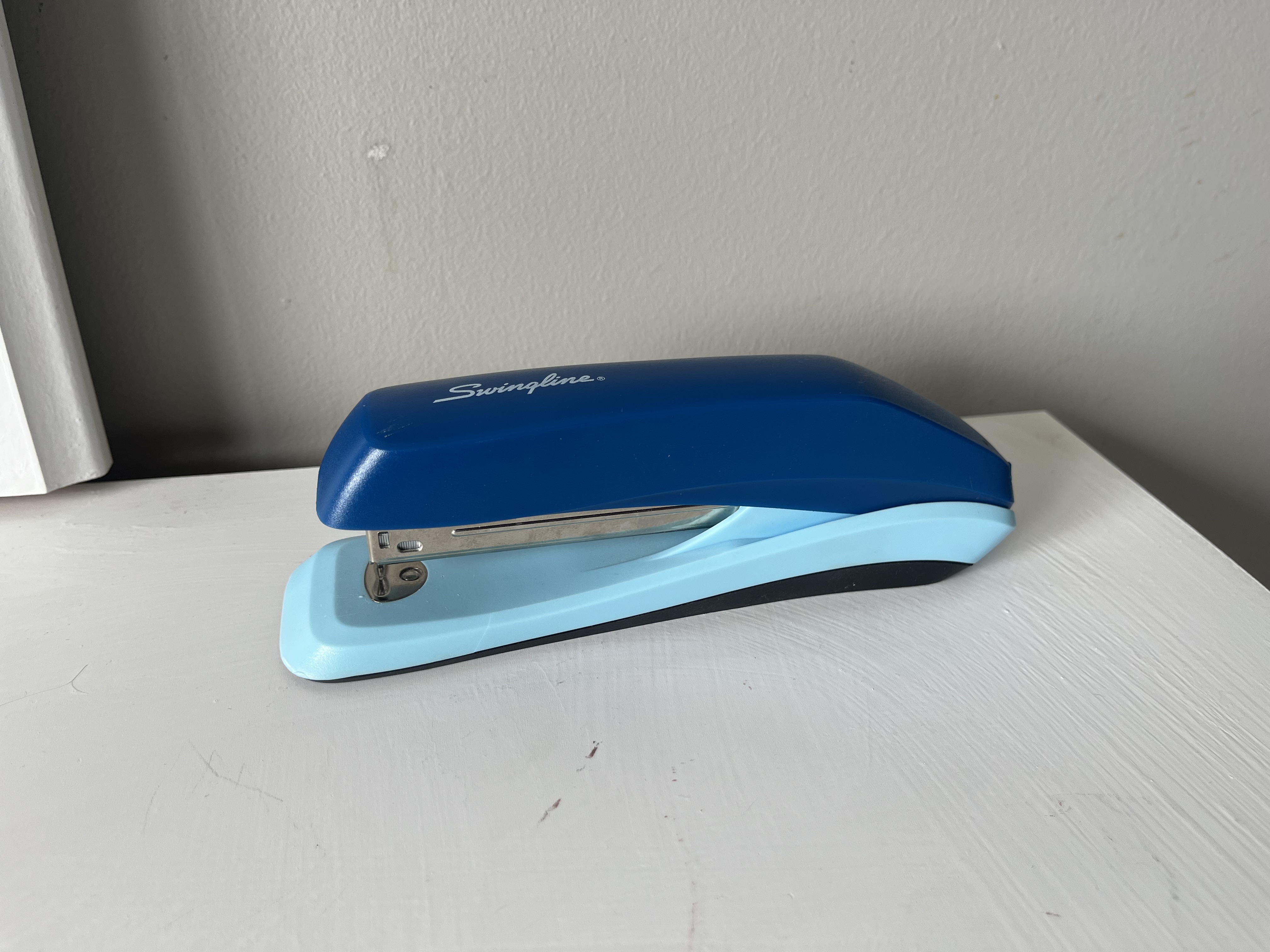 This is the sound of a stapler being pressed, producing a firm metal click as the staple is driven through the papers, followed by a slight spring-back release.